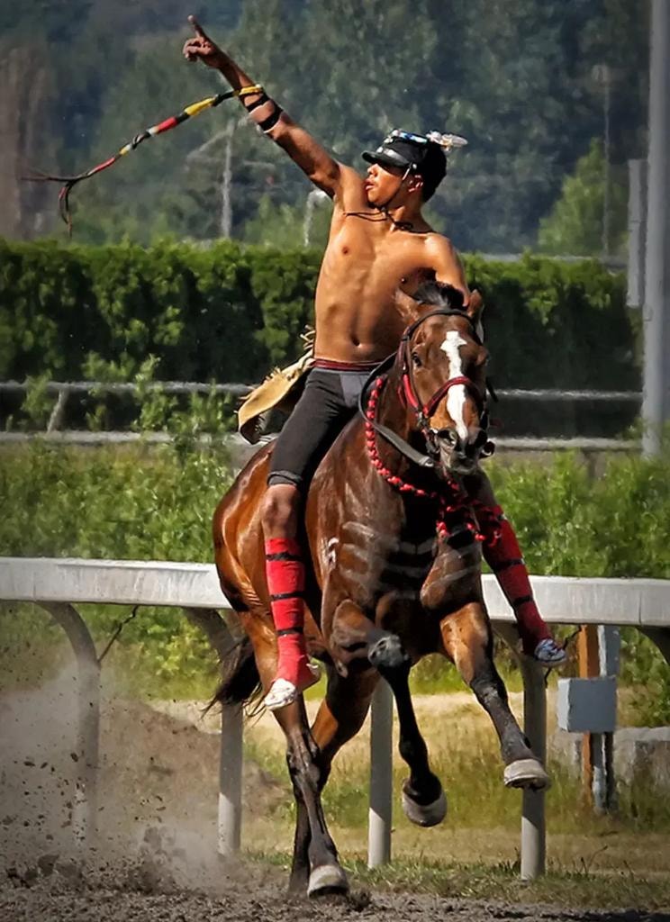Bareback rider switching horses at speed during Indian Relay Racing